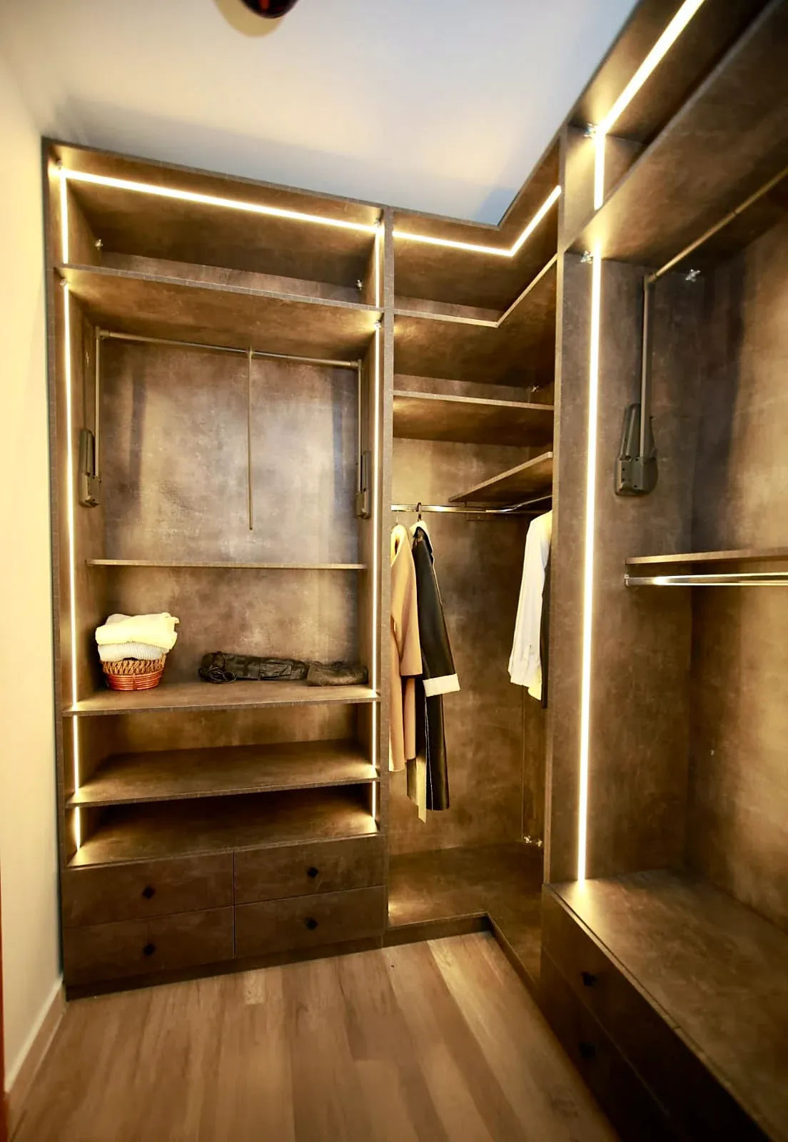 Open dressing room in a dark wood finish with LED lighting, built by Woodify